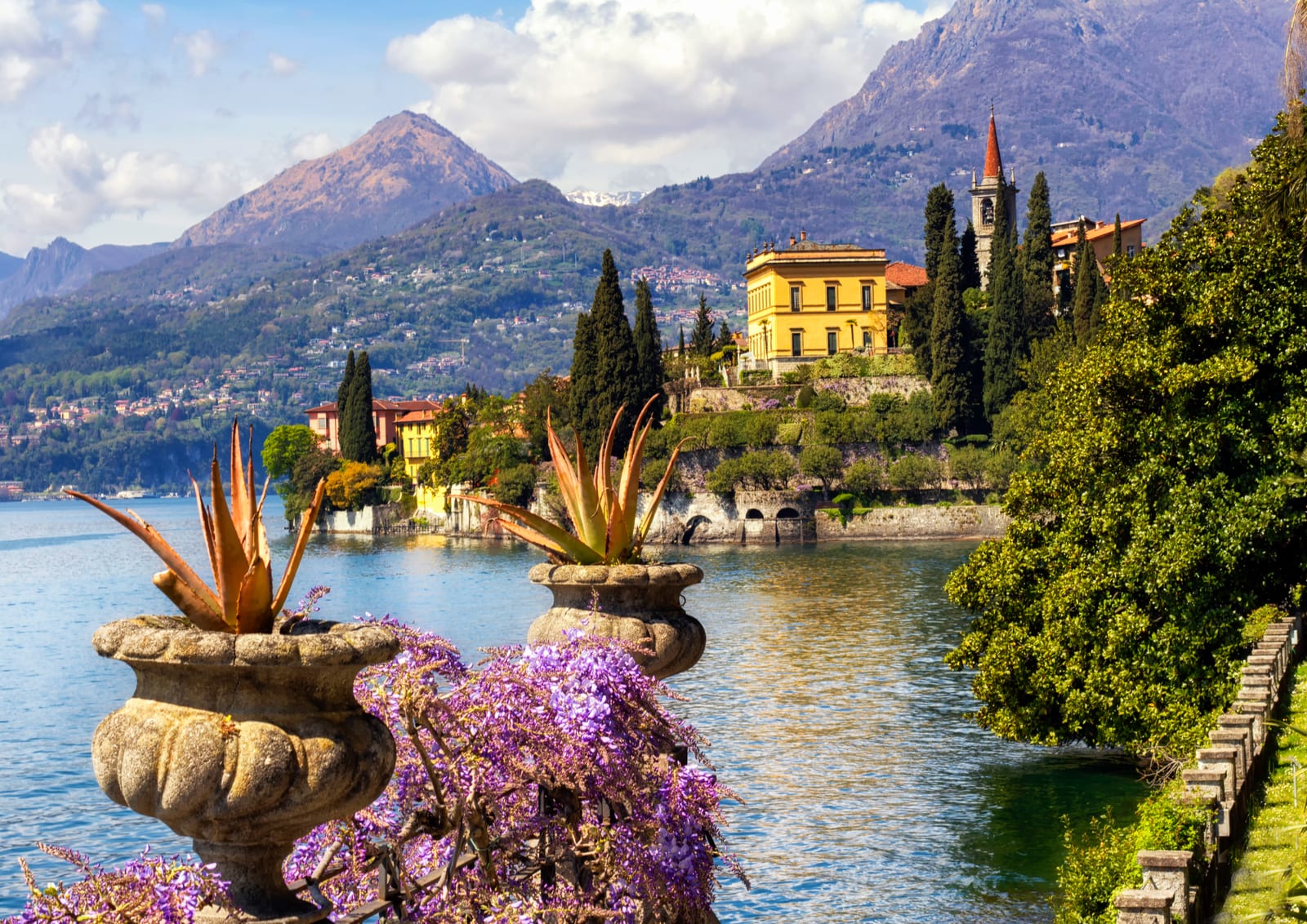 Pastel-coloured houses lining the waterfront of Varenna on Lake Como