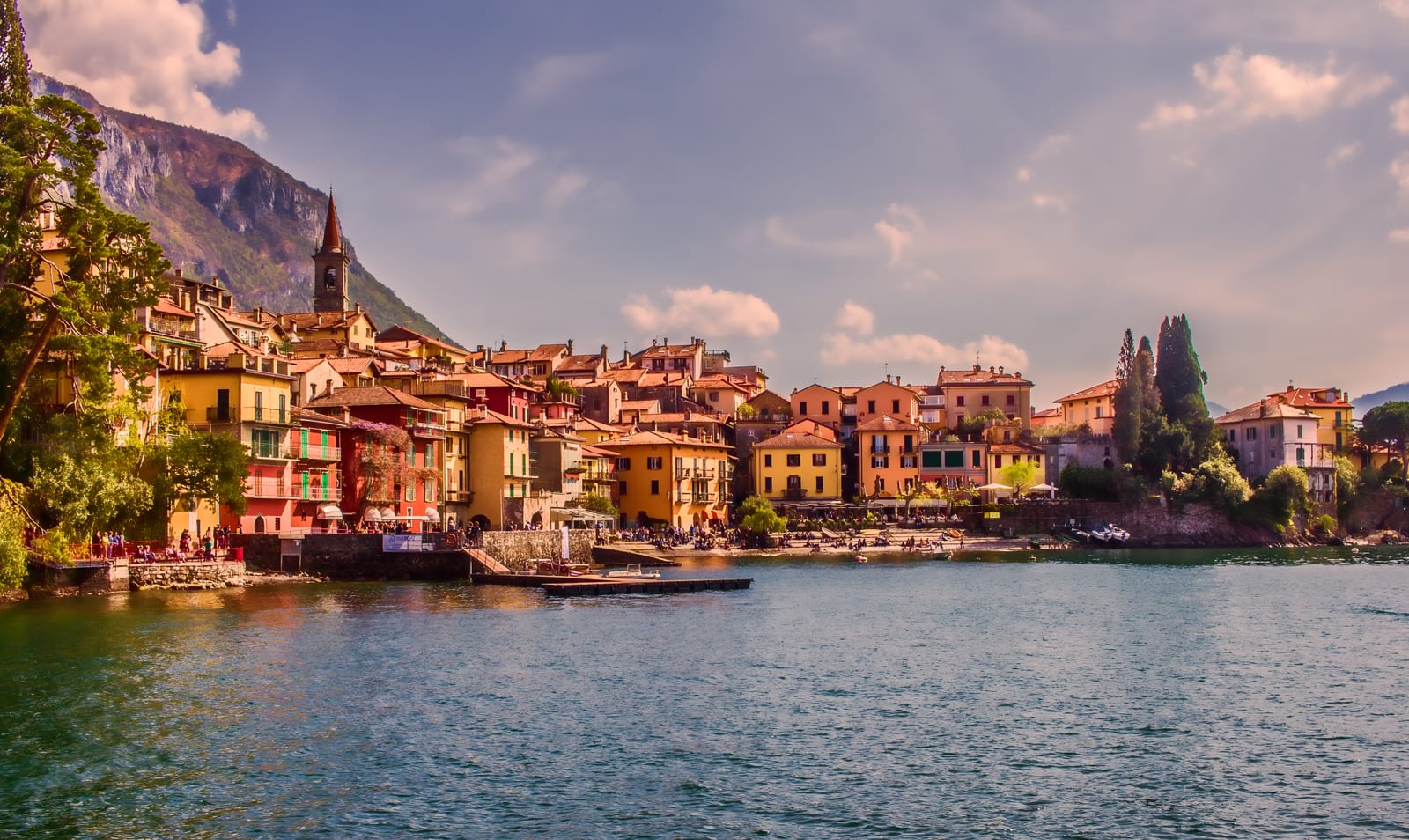 Colourful lakeside houses of Varenna seen from a boat on Lake Como