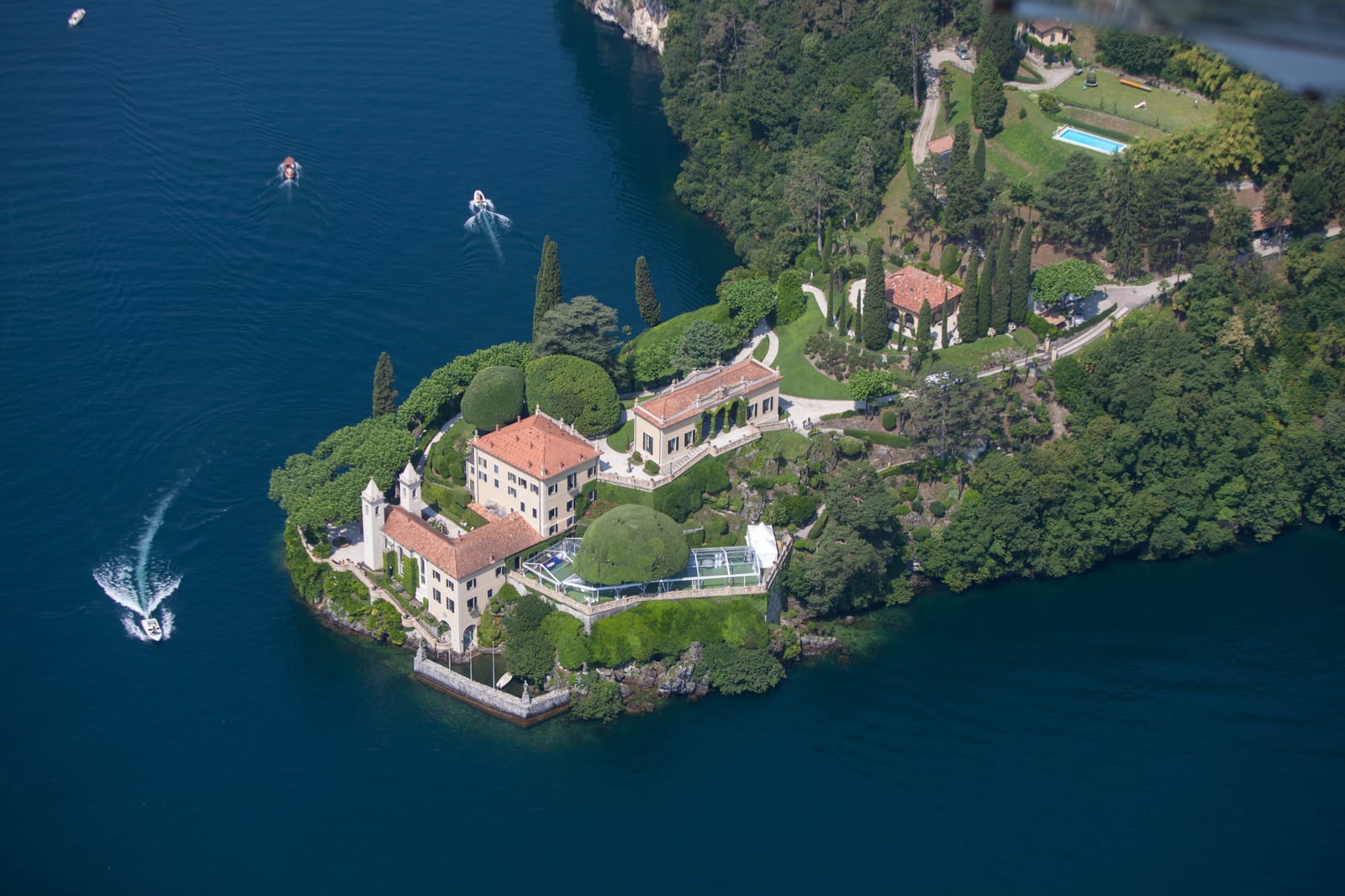 Villa del Balbianello and its terraced gardens on a wooded promontory over Lake Como